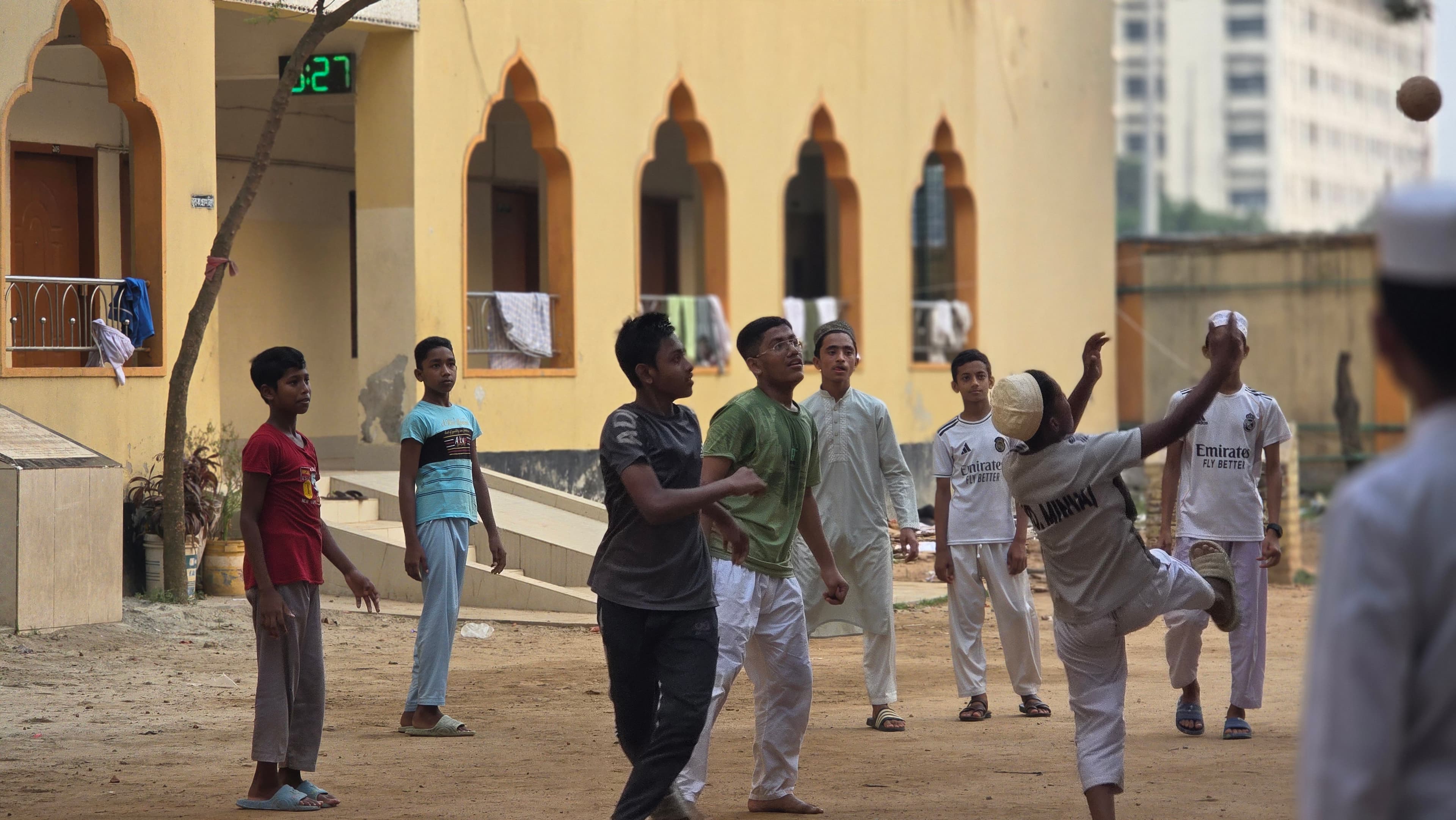 Young students enjoying recreation in the madrasa courtyard after studies.