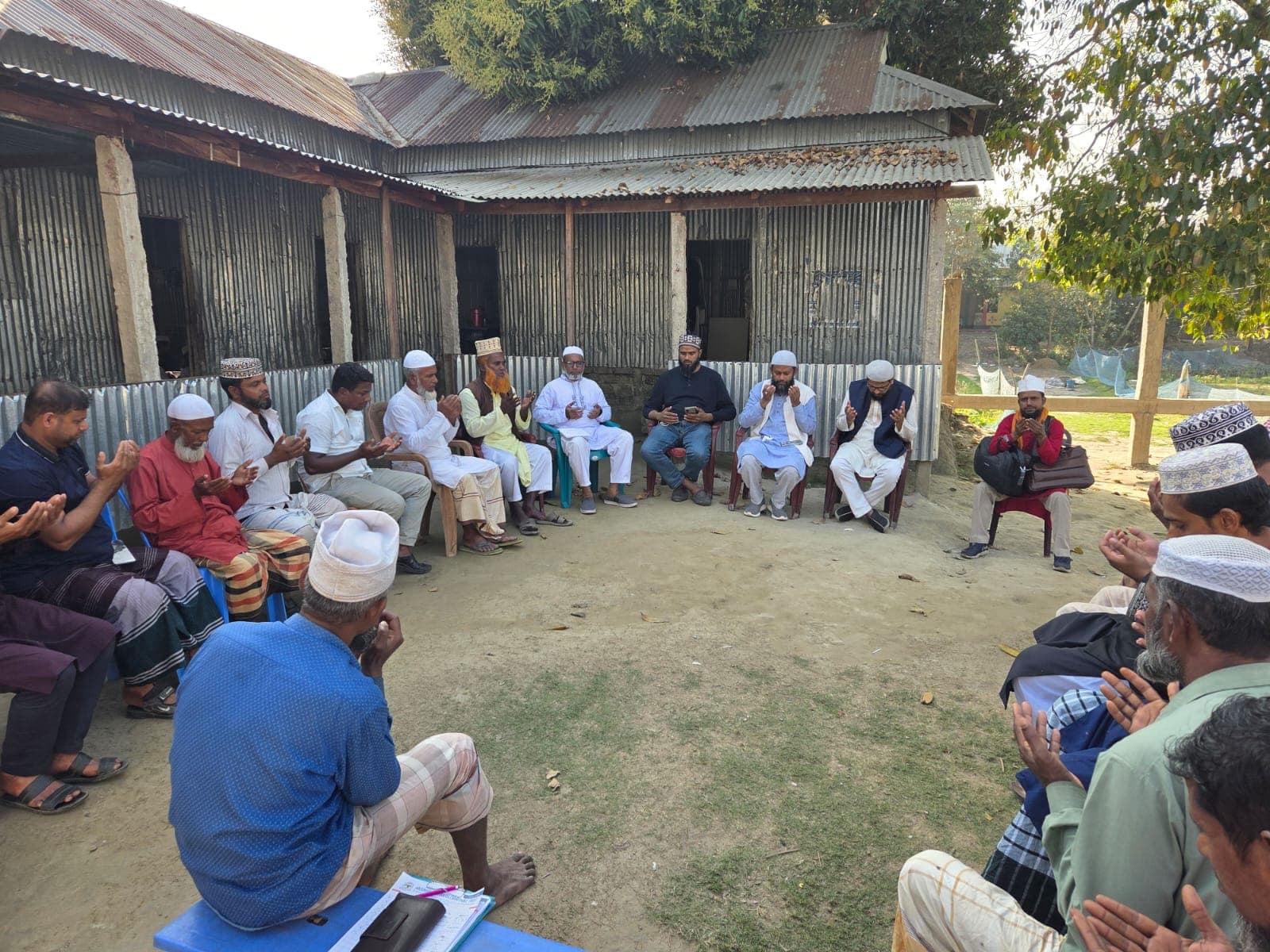 Elders and villagers united in du'a for the welfare of the community.