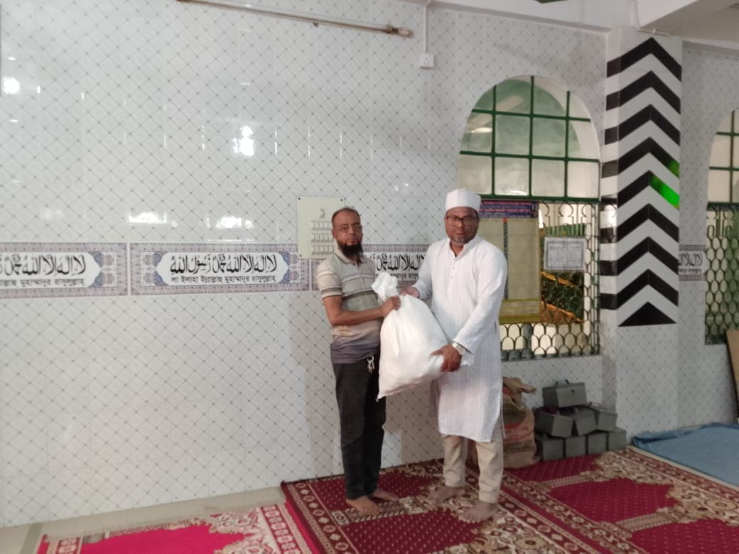 Essential food supplies delivered to a family in need at the mosque.